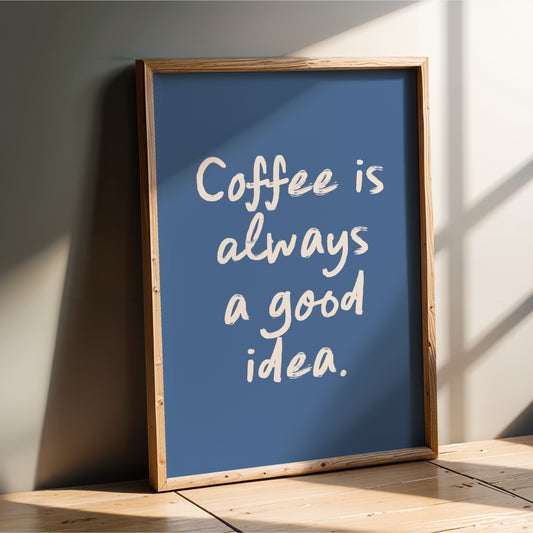 A framed poster with the text "Coffee is always a good idea" against a blue background.