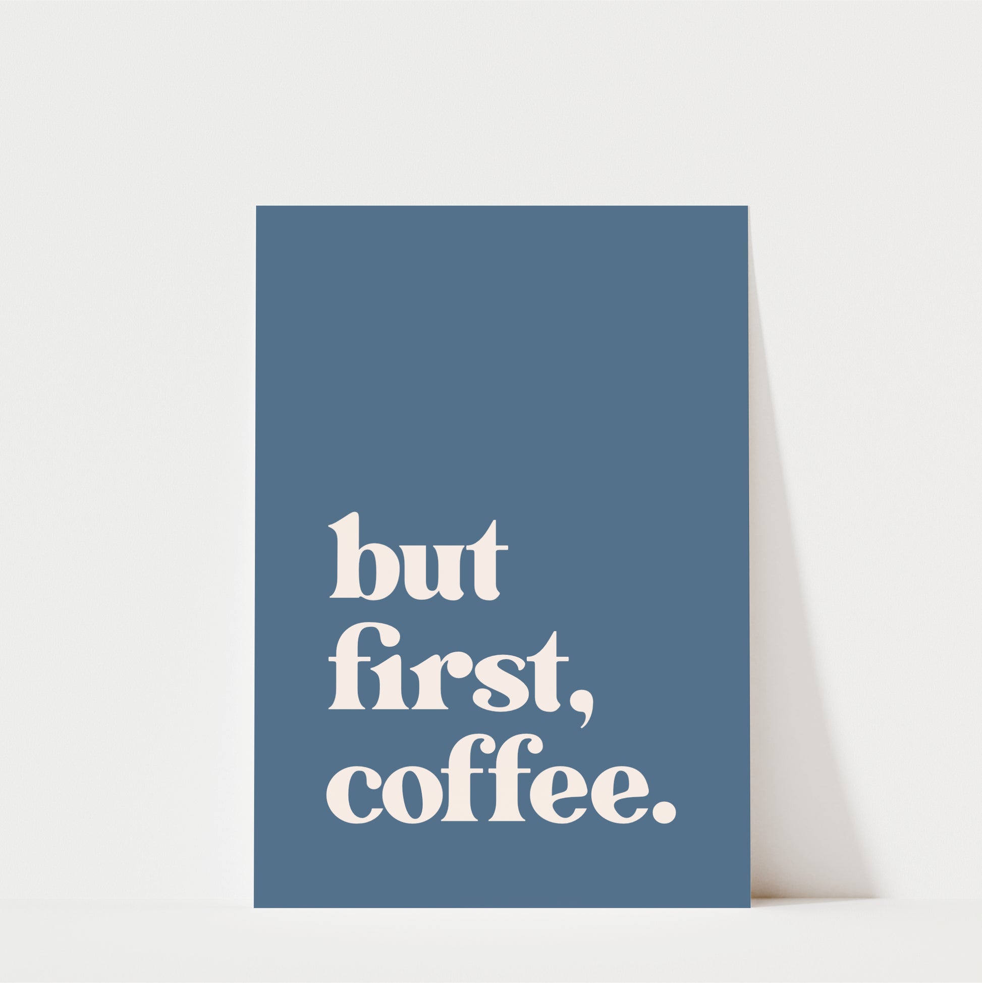 A blue poster with the text "but first, coffee."