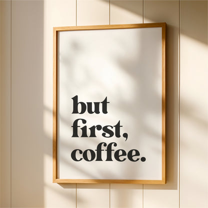 A framed poster with the text "but first, coffee."