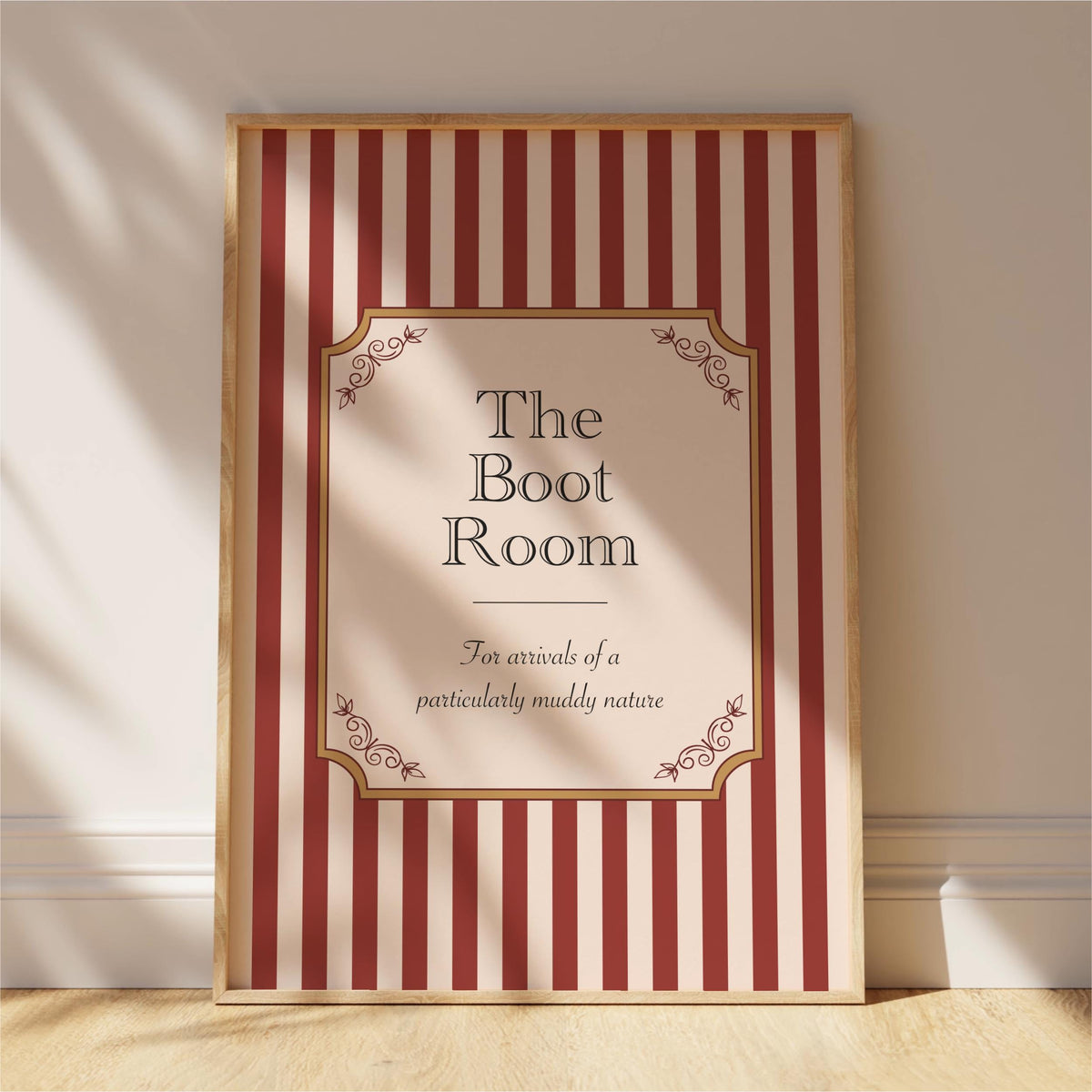 a framed sign with a striped pattern and decorative elements, standing on a wooden floor against a white wall.