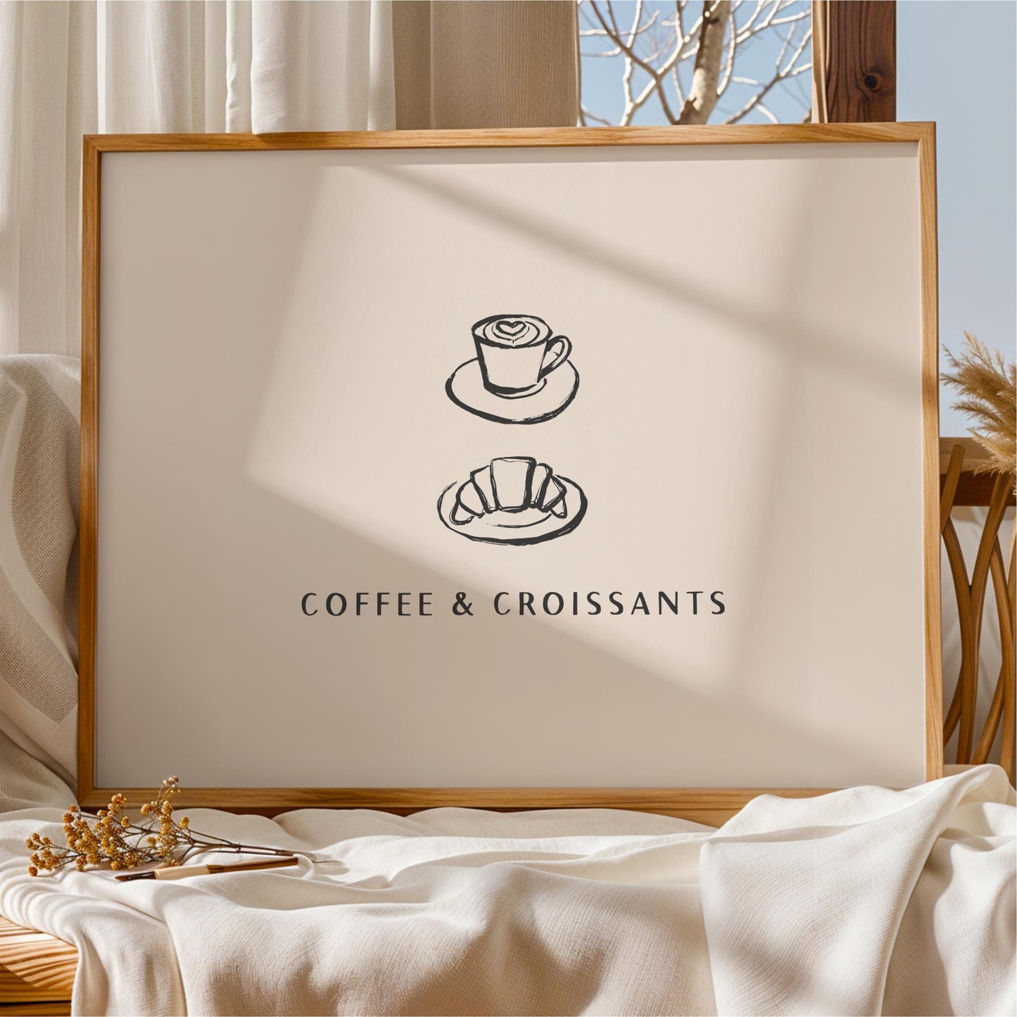 a framed poster with the text "COFFEE & CROISSANTS" and two illustrations of coffee cups and croissants.