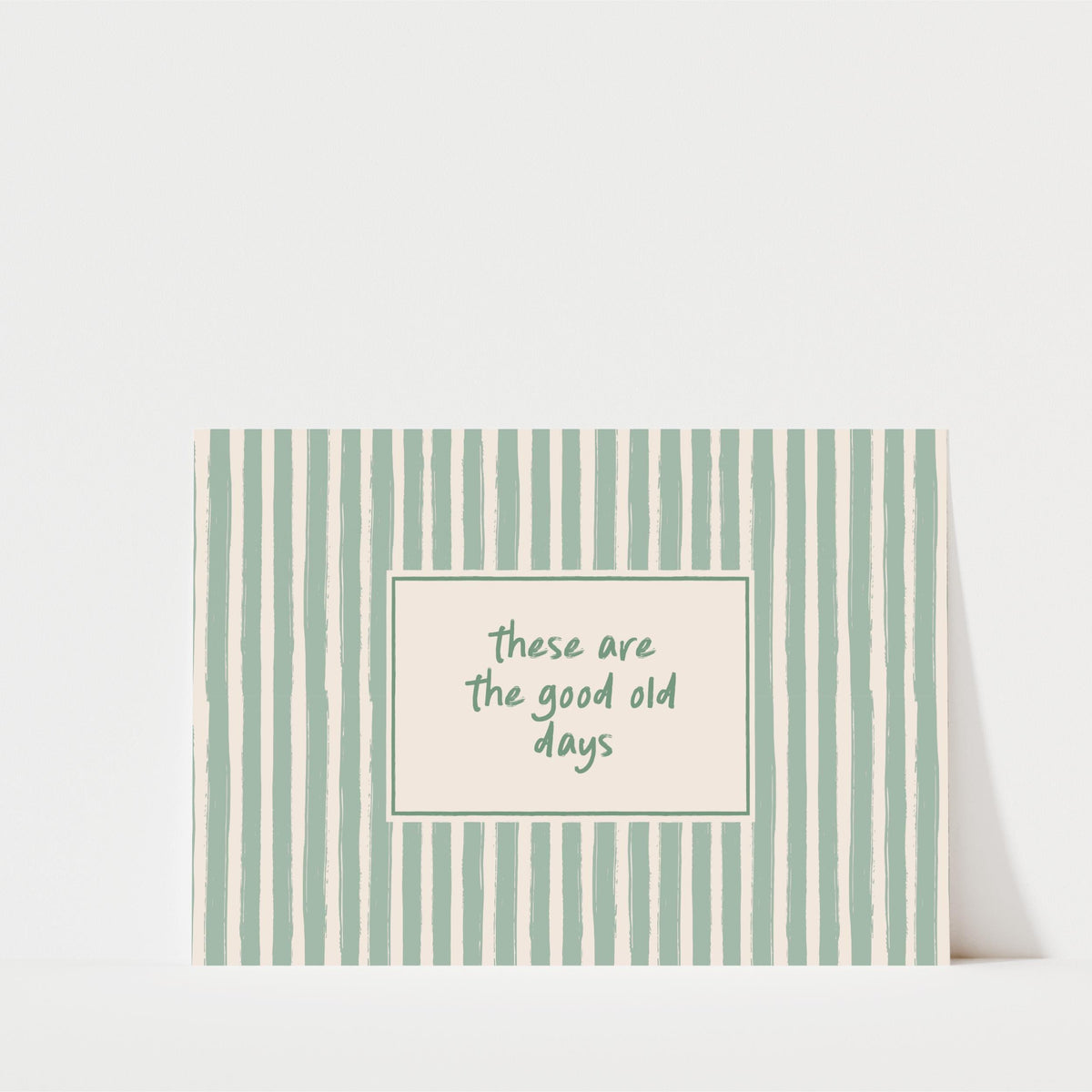 A rectangular card with a green and white striped pattern, featuring a message that reads "These are the good old days" in a smaller font size.