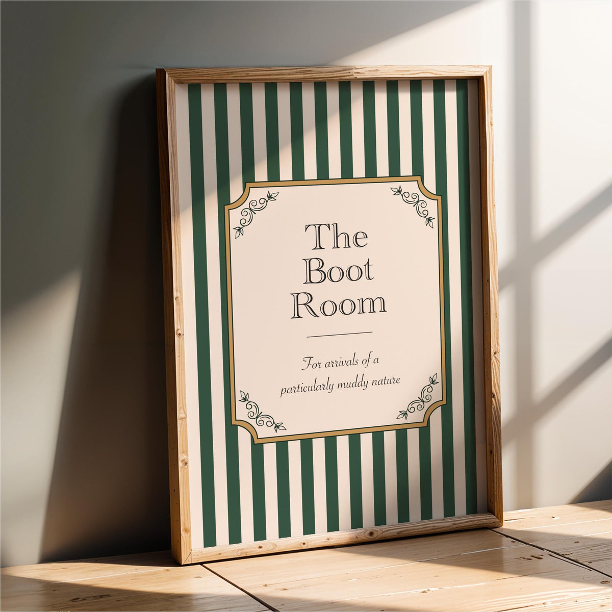 a framed sign with a green and white striped background and decorative elements, indicating that it is a sign for "The Boot Room".