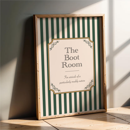 a framed sign with a green and white striped background and decorative elements, indicating that it is a sign for "The Boot Room".