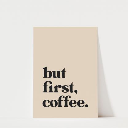 A beige-colored poster with the text "but first, coffee." printed on it.