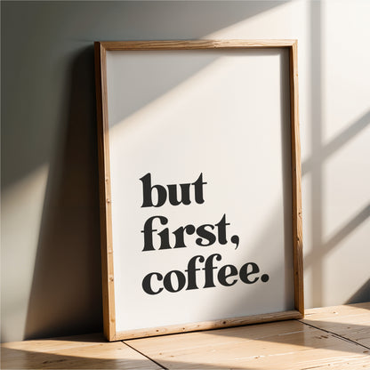 A framed poster with the text "but first, coffee."