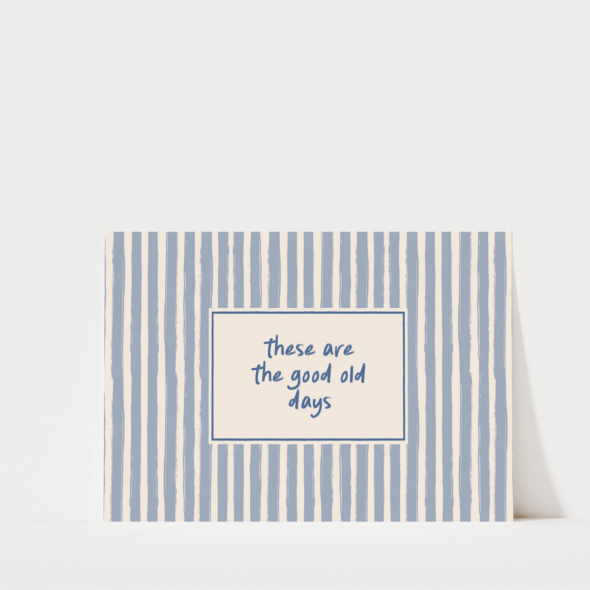 A greeting card with a blue and white striped background and a message that reads "These are the good old days" in the center.