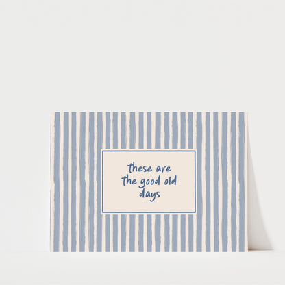 A greeting card with a blue and white striped background and a message that reads "These are the good old days" in the center.