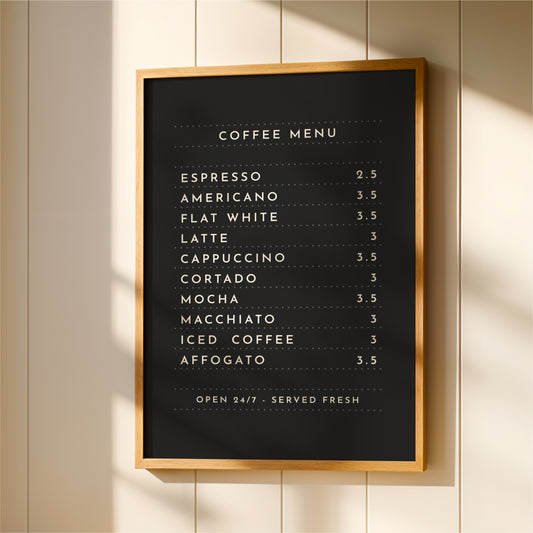 a black and white coffee menu board hanging on a wall.