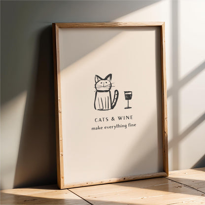 a framed poster with a cat and wine glass illustration, accompanied by the text "CATS & WINE make everything fine".