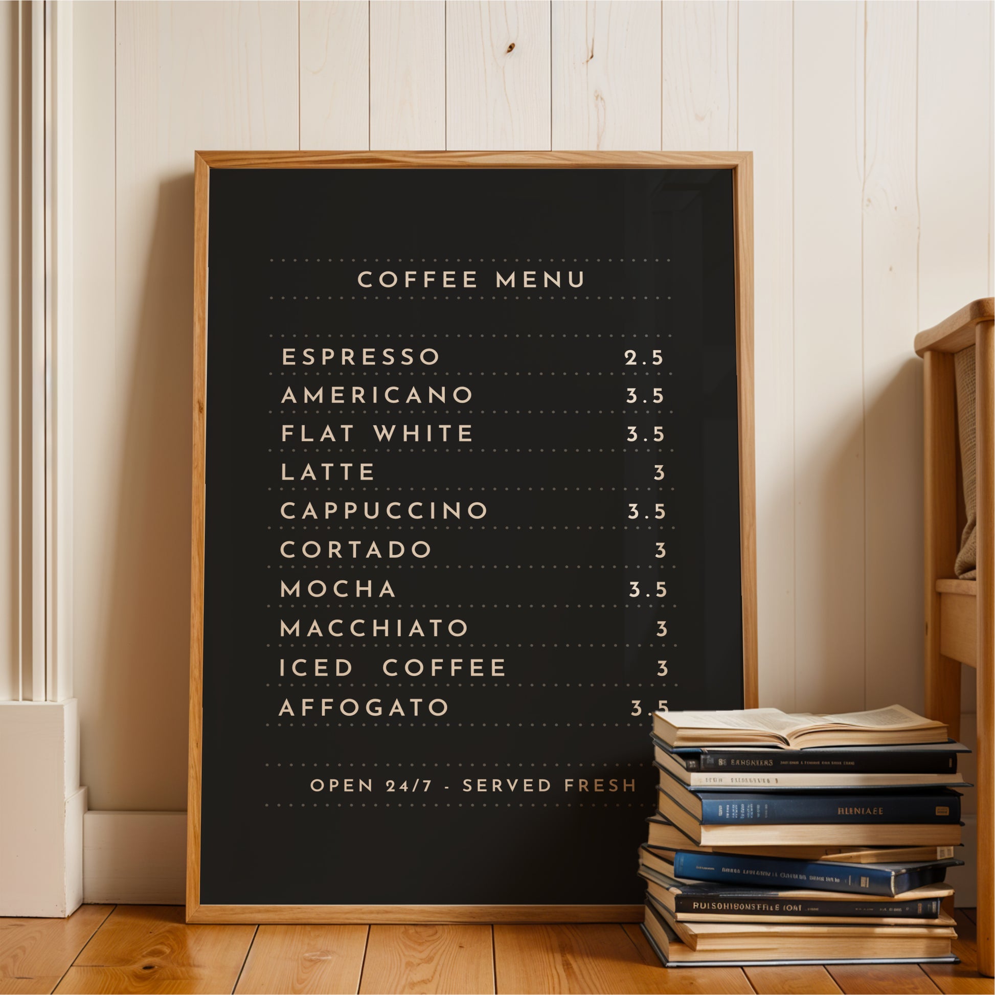 A black coffee menu board with a list of coffee drinks and their prices, placed on a wooden floor next to a stack of books.
