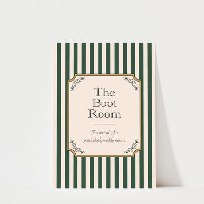 The image is a poster or sign with a striped background and a decorative border. The text on the poster reads "The Boot Room" and "For arrivals of a particularly muddy nature".