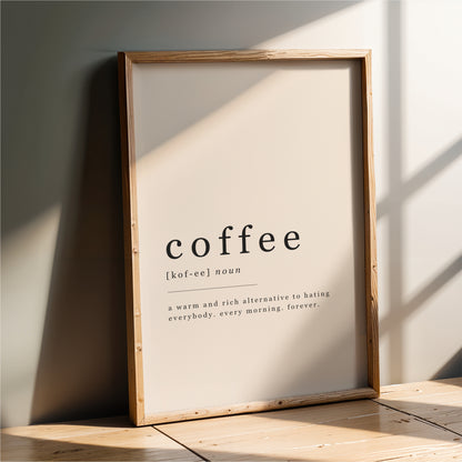 A wooden frame with a white poster that defines "coffee" as a warm and rich alternative to hot beverages, stating that it is a "warmer and richer alternative to hot beverages" and "every morning, forever".