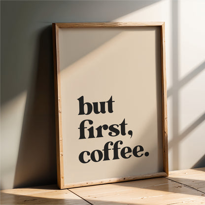 A framed poster with the text "but first, coffee."