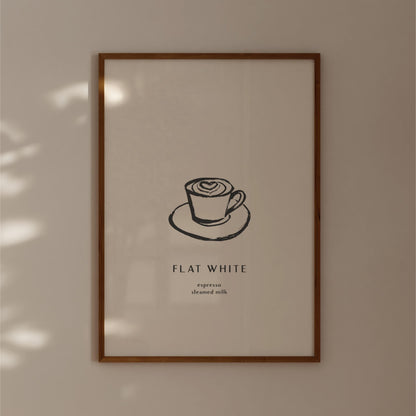a framed poster with a simple black and white illustration of a cup of coffee on a saucer, accompanied by the text "FLAT WHITE" and "emphasized steamed milk" in a smaller font size.