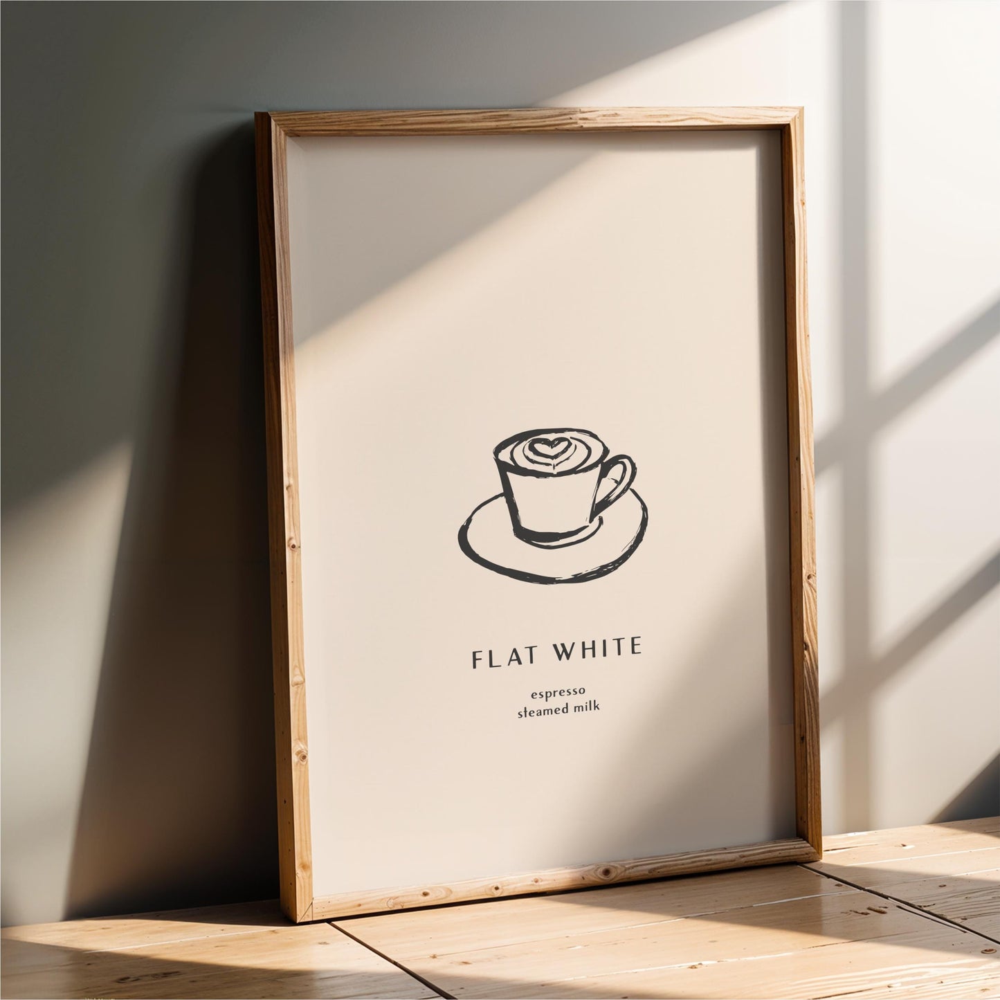 a framed poster with a simple black and white illustration of a cup of coffee on a saucer, along with the text "FLAT WHITE" and "expression steeped milk" below it.