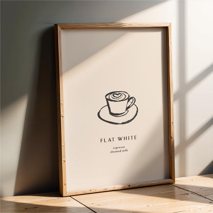 a framed poster with a simple black and white illustration of a cup of coffee on a saucer, along with the text "FLAT WHITE" and "expression steeped milk" below it.
