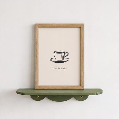 A framed poster with a simple illustration of a cup of tea on a saucer, accompanied by the text "TEA PLEASE" in a casual, friendly font.