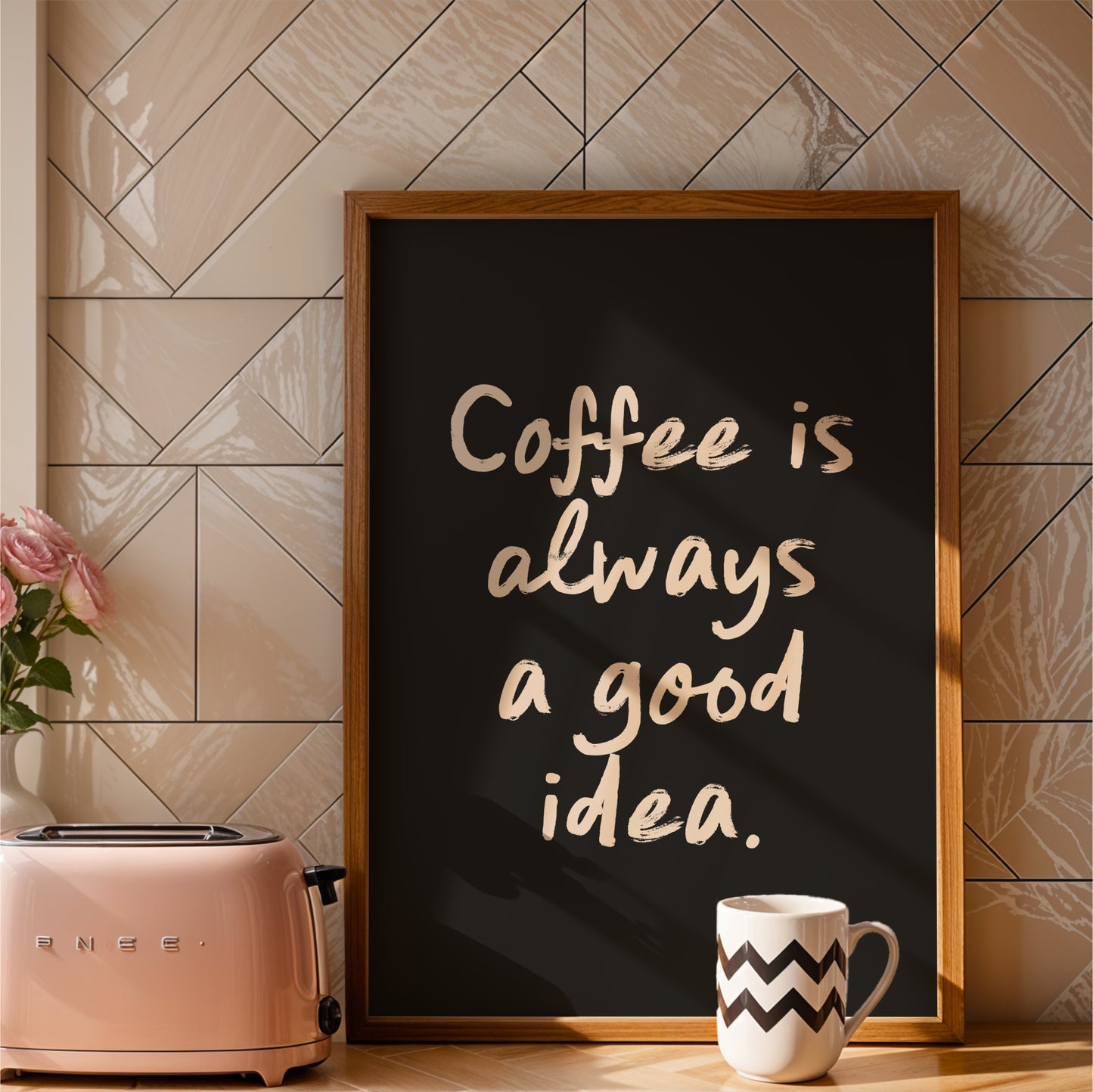 a framed sign with the text "Coffee is always a good idea" and a pink toaster on a kitchen counter.