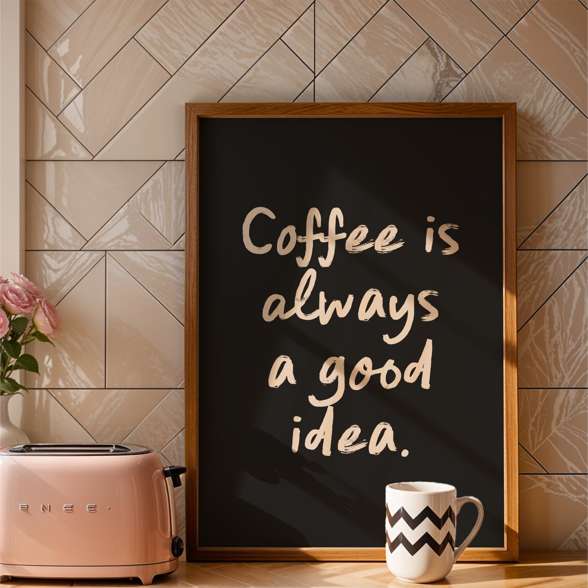 a framed sign with the text "Coffee is always a good idea" and a pink toaster on a kitchen counter.