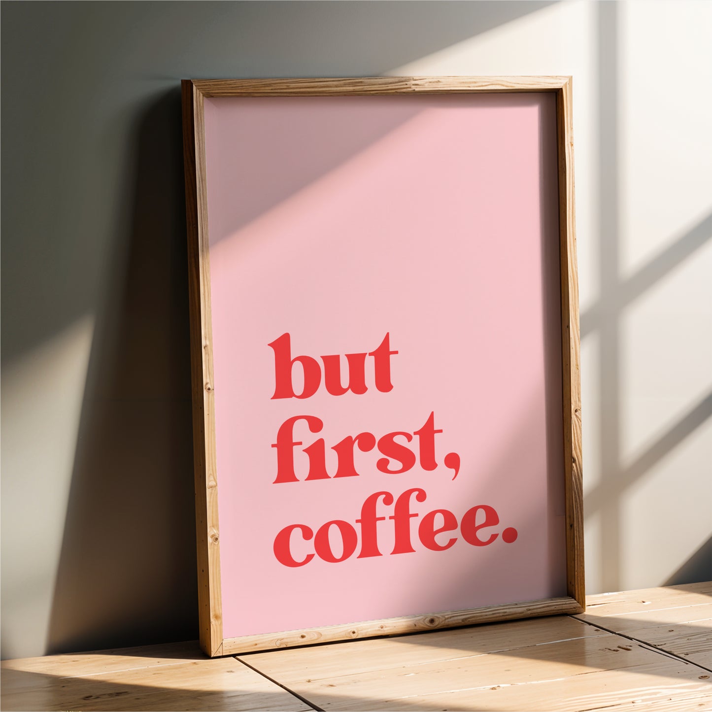 A framed poster with the text "but first, coffee."