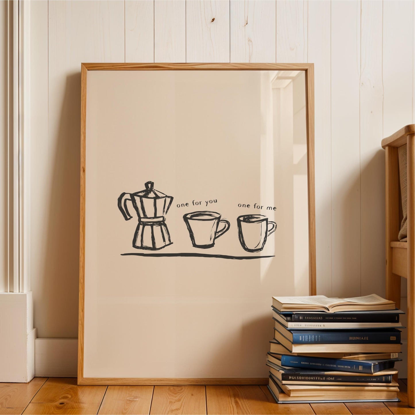 A framed poster with a simple black and white illustration of a coffee maker and two mugs, accompanied by the text "one for you one for me".