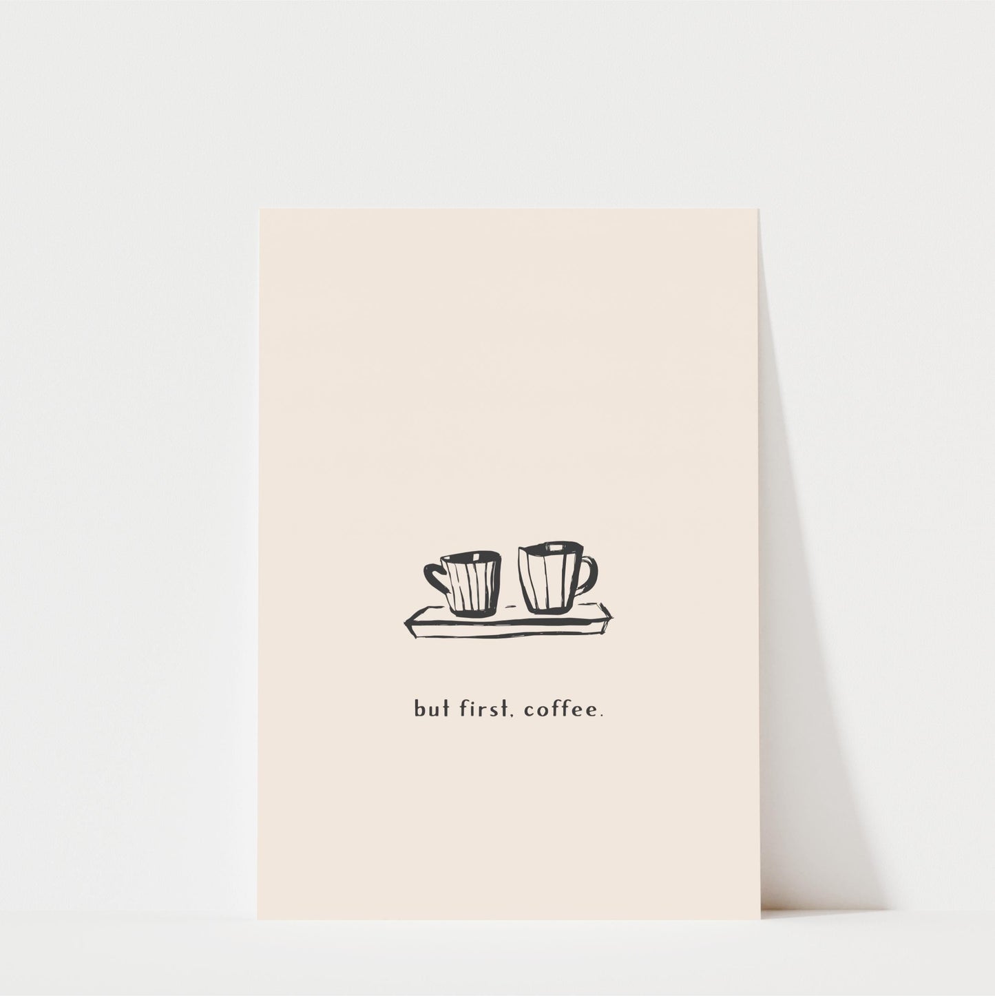 A simple illustration of two coffee cups on a tray, accompanied by the text "but first. coffee."