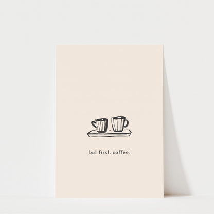 A simple illustration of two coffee cups on a tray, accompanied by the text "but first. coffee."