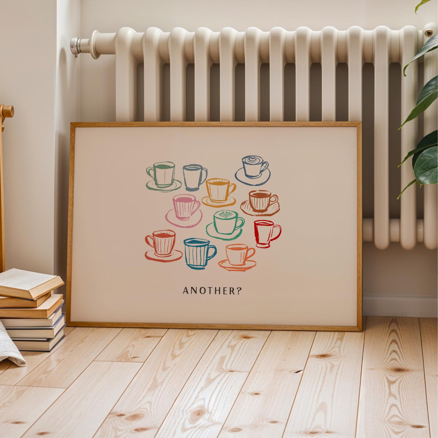 A framed poster with a colorful illustration of various coffee cups and saucers, accompanied by the text "Another?"