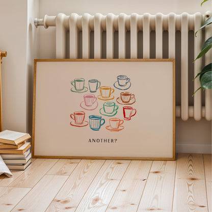 A framed poster with a colorful illustration of various coffee cups and saucers, accompanied by the text "Another?"