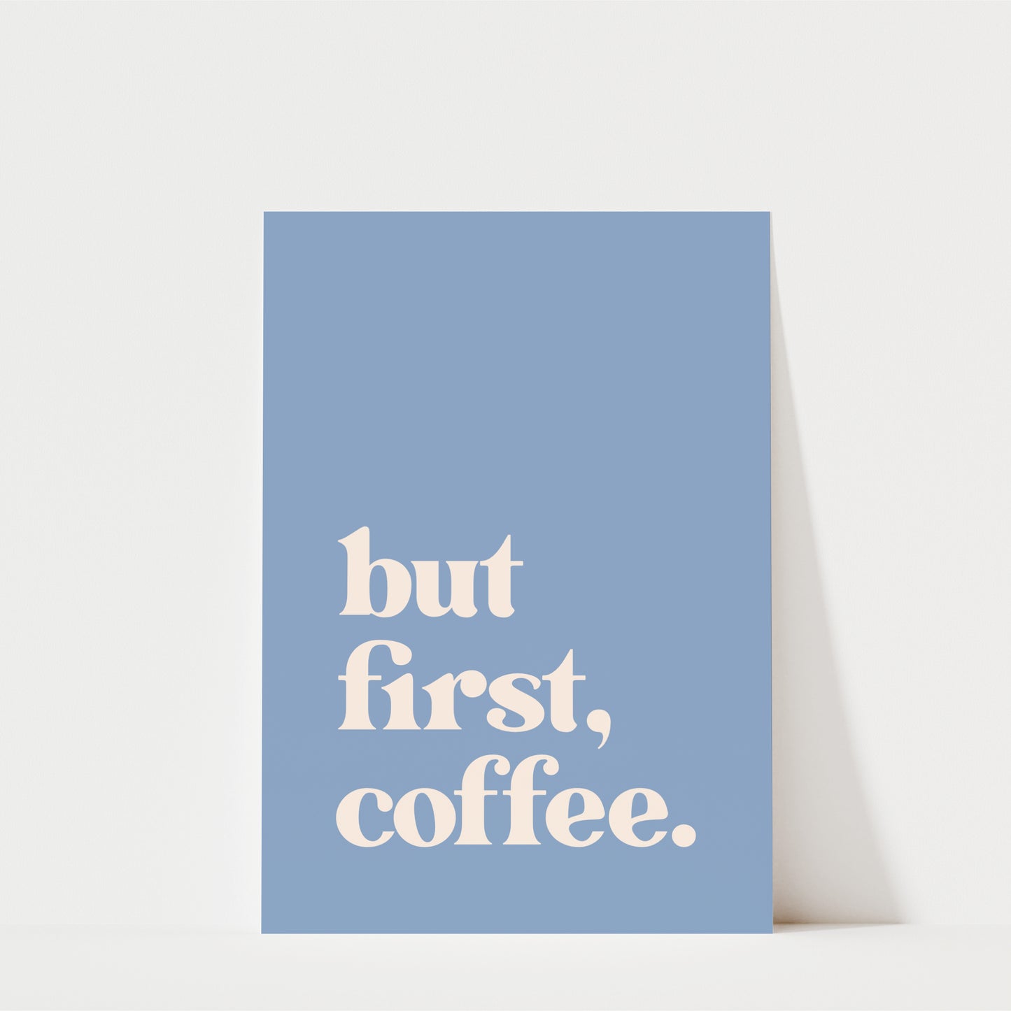 A blue poster with the text "but first, coffee."
