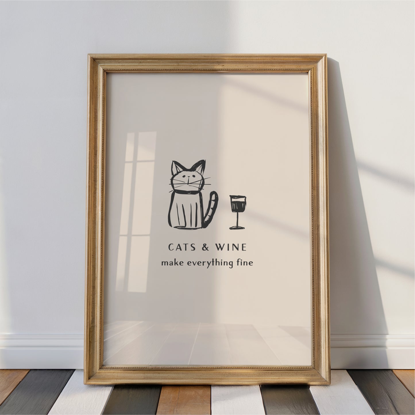 A framed poster with a cartoon cat and a wine glass, accompanied by the text "CATS & WINE make everything fine".