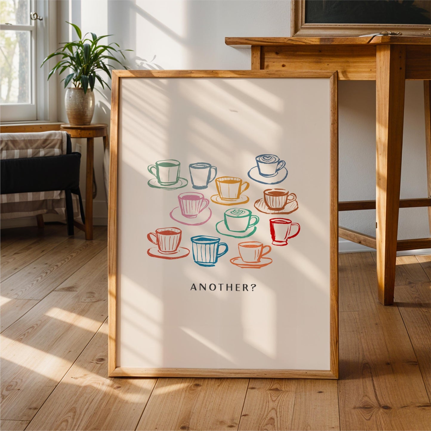 a framed poster with a colorful illustration of various coffee cups and saucers, accompanied by the text "Another?"