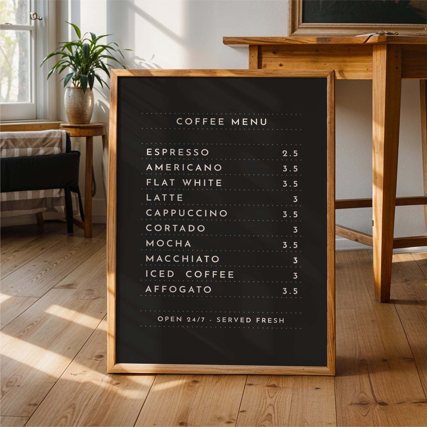 A black coffee menu sign is displayed on a wooden floor in a room with a potted plant and a wooden table.