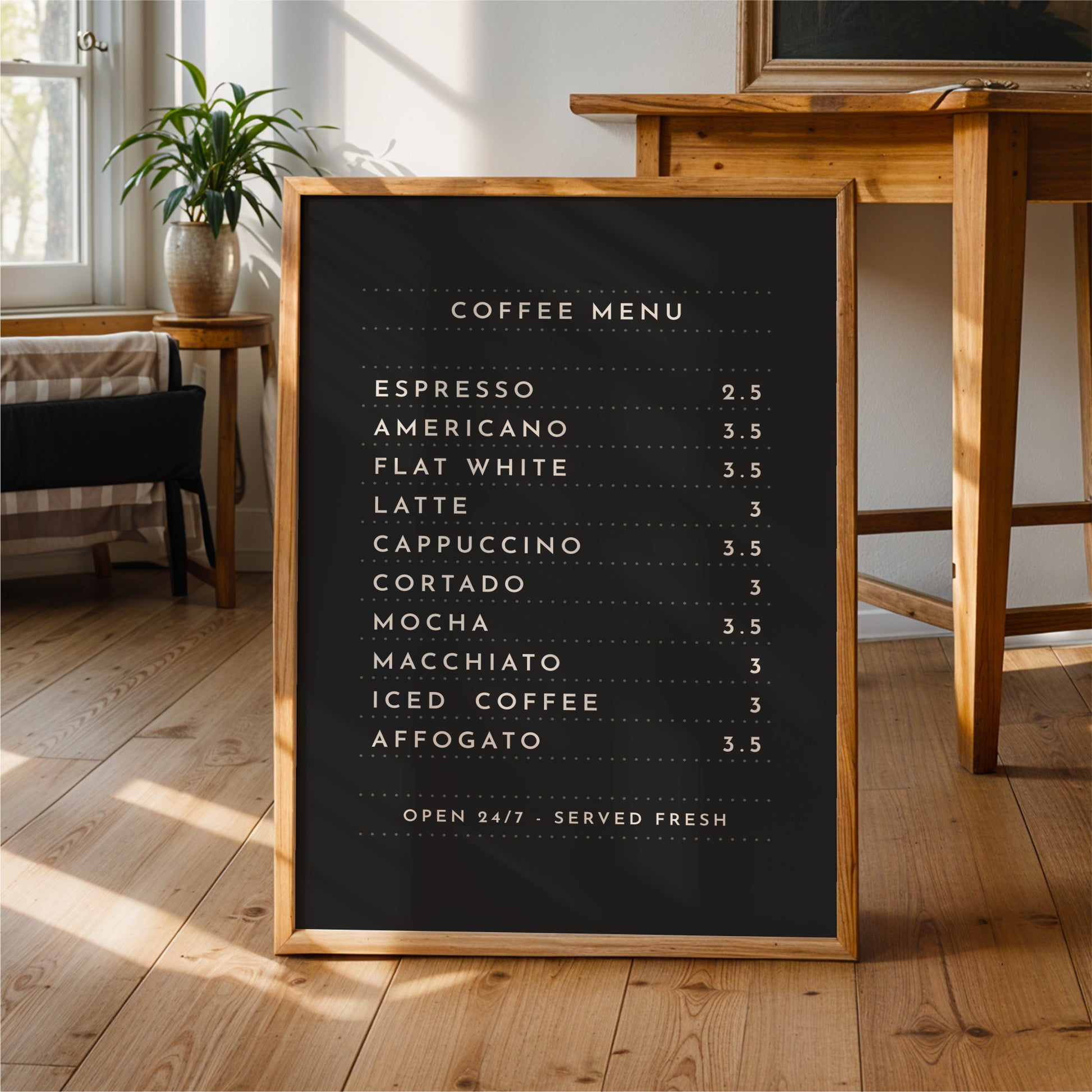 A black coffee menu sign is displayed on a wooden floor in a room with a potted plant and a wooden table.
