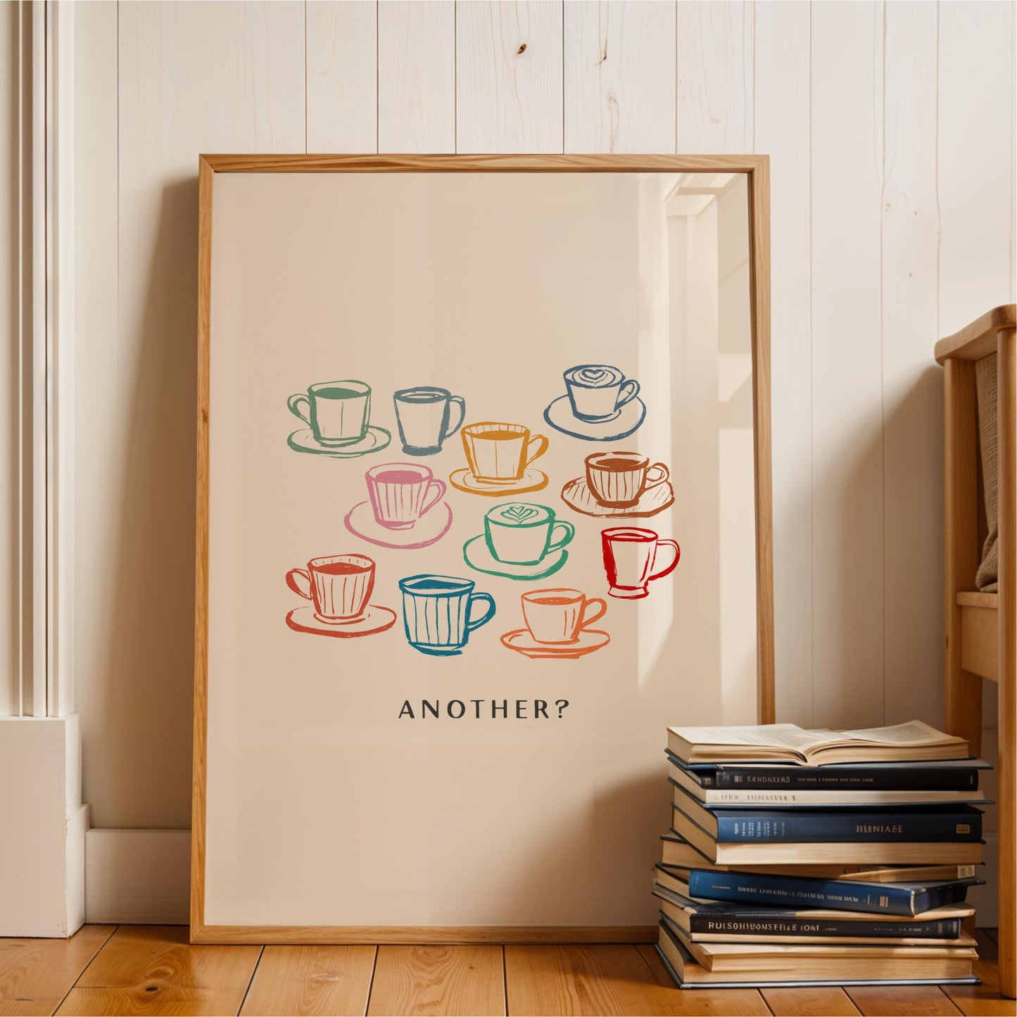 A framed poster with a colorful illustration of various coffee cups and saucers, accompanied by the text "ANOTHER?"