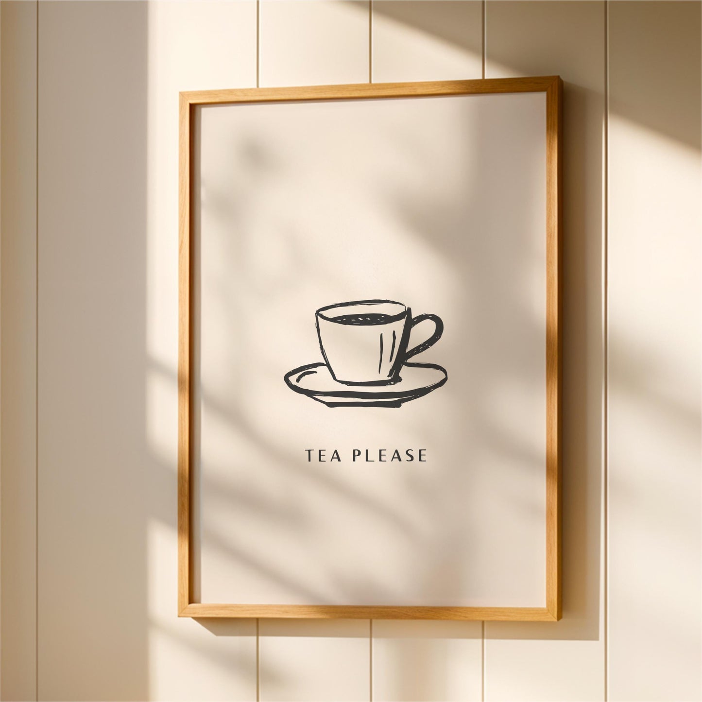 A framed poster with a simple black and white illustration of a cup of tea on a saucer, accompanied by the text "TEA PLEASE" in a bold, capitalized font.