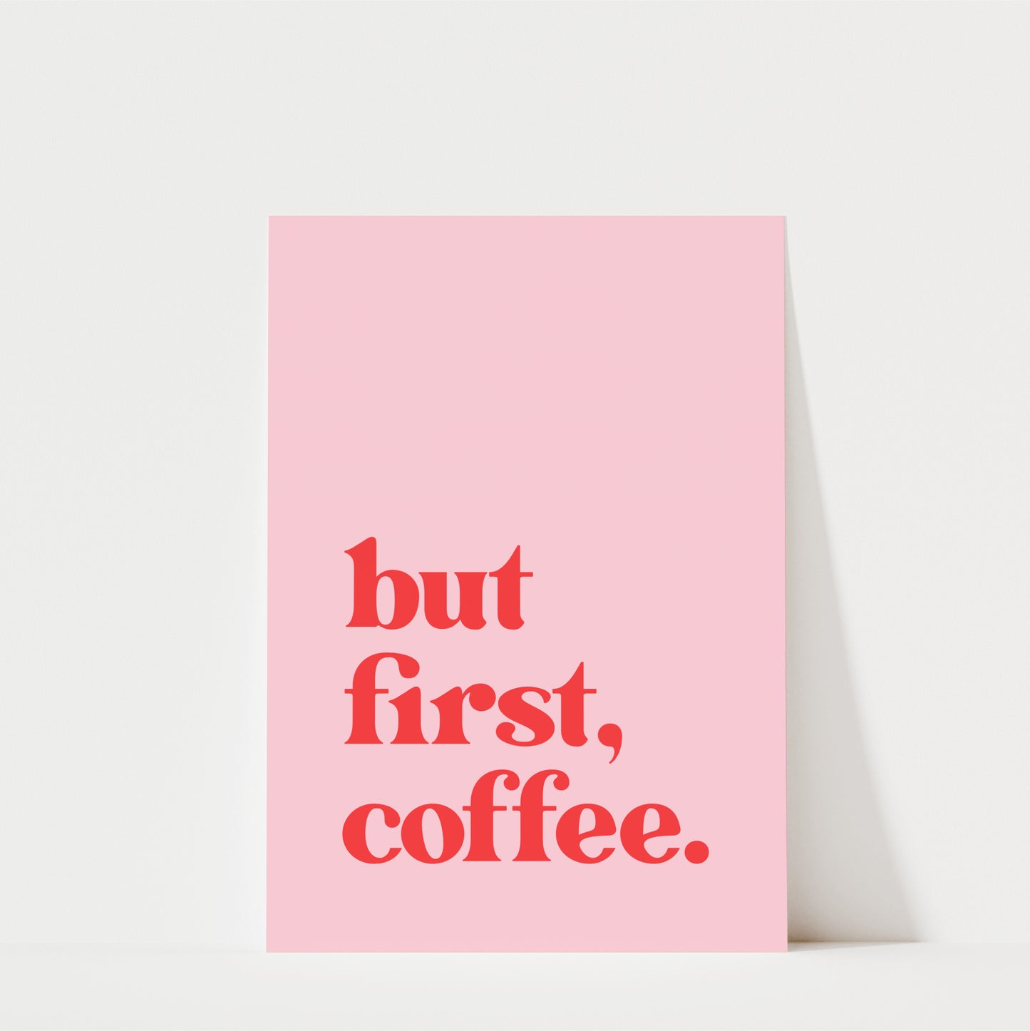 A pink poster with the text "but first, coffee."