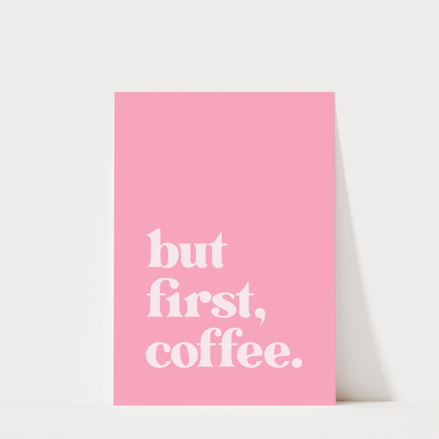 A pink poster with the text "but first, coffee."