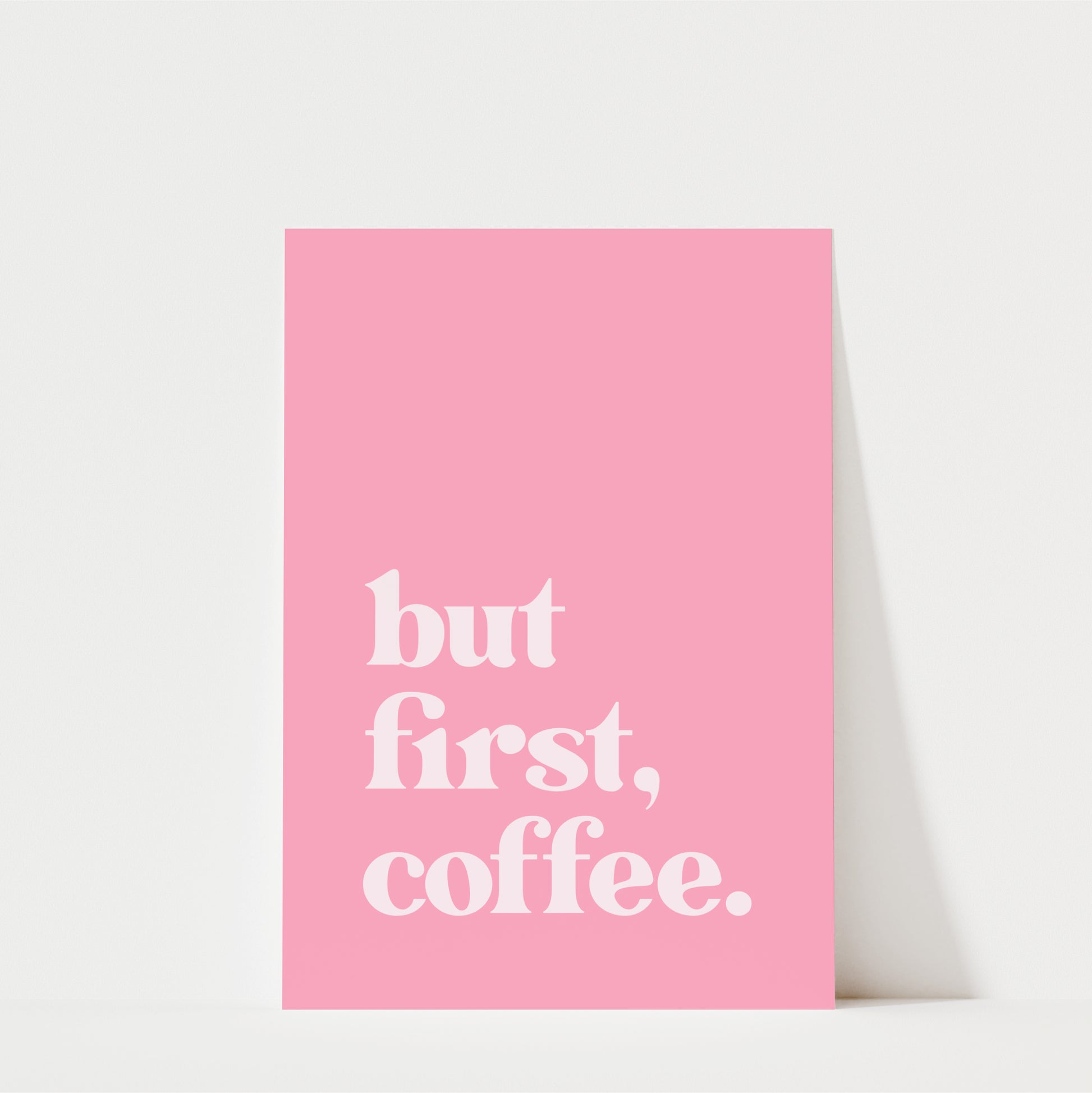 A pink poster with the text "but first, coffee."