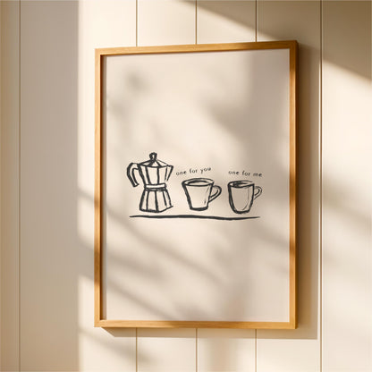 a framed artwork with a simple black and white illustration of a coffee maker and two cups, accompanied by the text "one for you one for me".