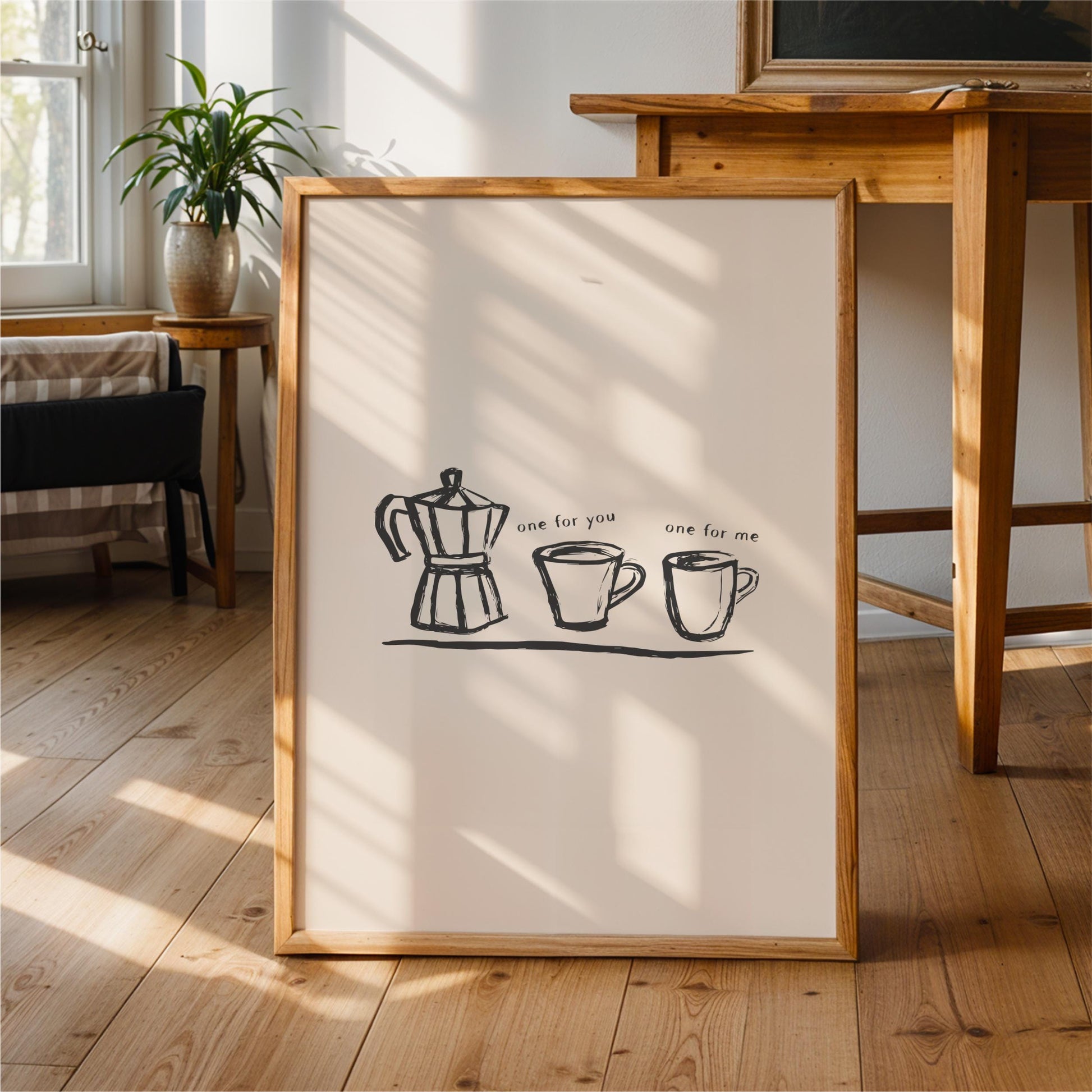 a framed artwork depicting a coffee maker and two coffee cups, accompanied by the text "one for me".
