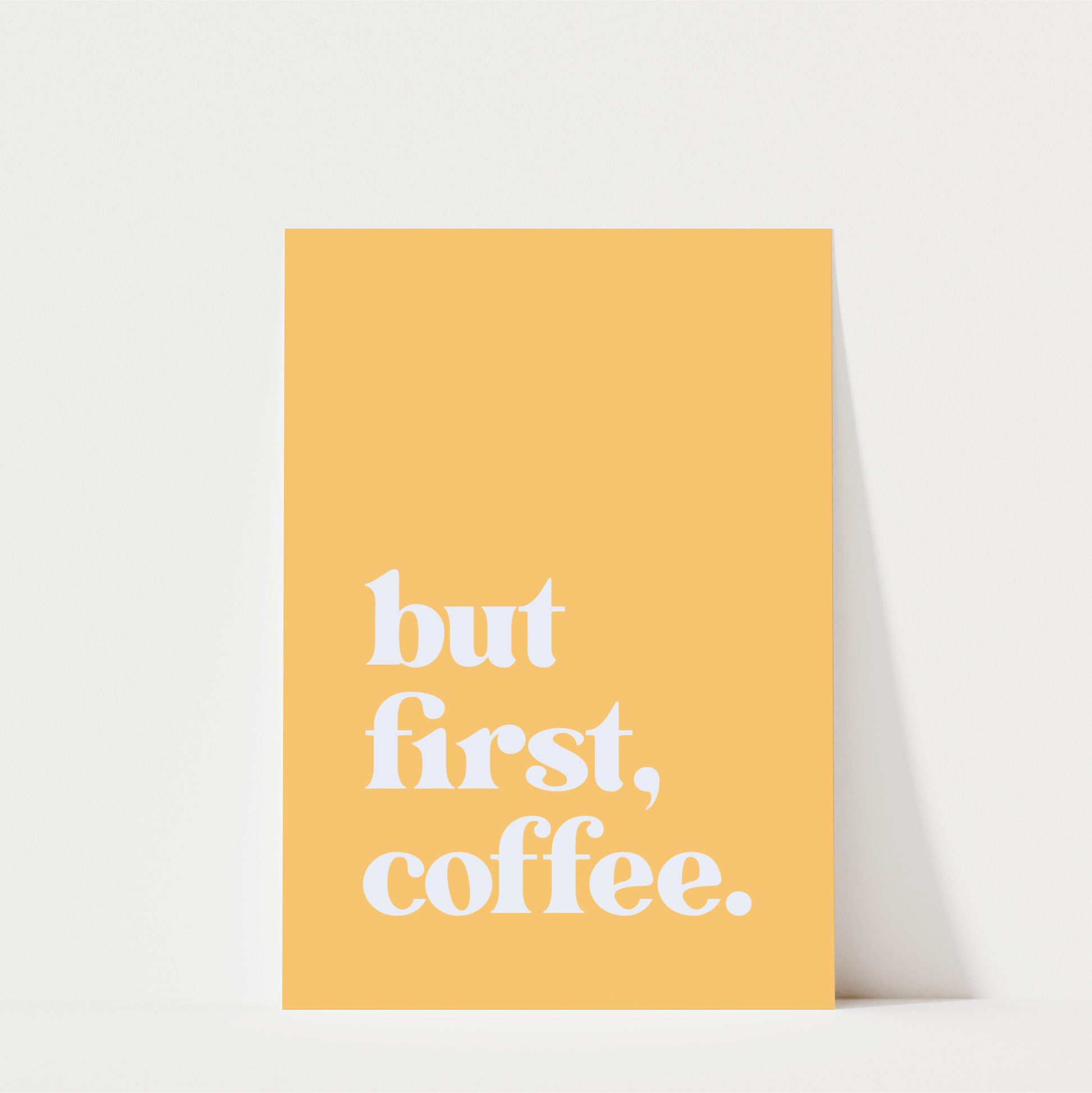 A yellow poster with the text "but first, coffee."