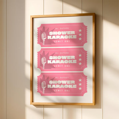 A framed poster with three pink tickets for a shower karaoke event, each with a microphone and the text "SHOWER KARAOKE ADMIT ONE" printed on them.