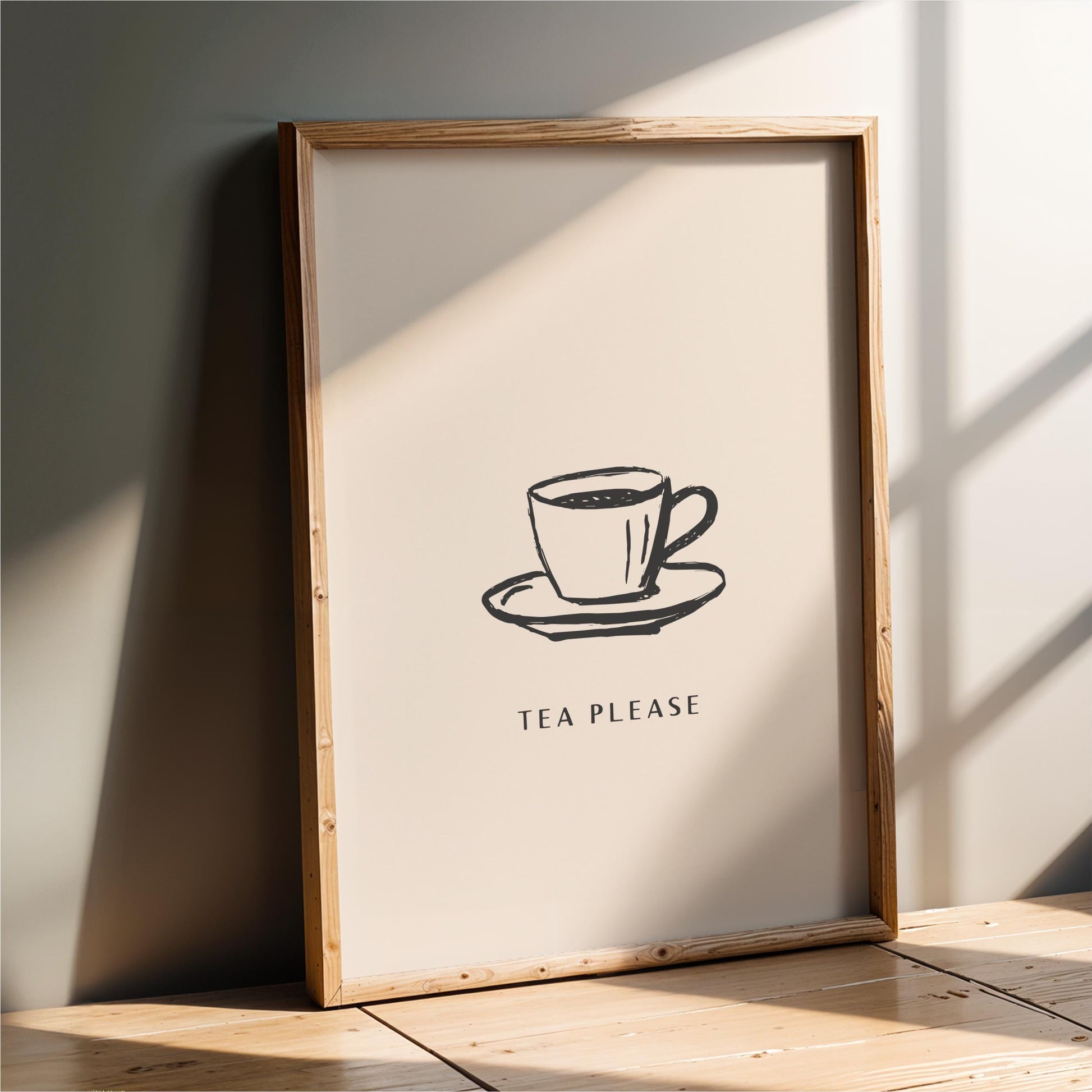 A framed poster with a simple black and white illustration of a cup of tea on a saucer, accompanied by the text "TEA PLEASE".