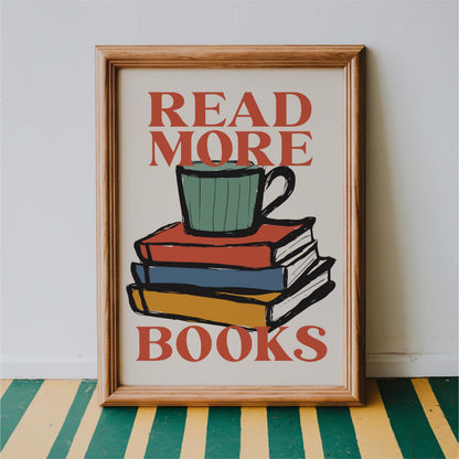 a framed poster with the text "READ MORE BOOKS" and an illustration of a stack of books with a mug on top.