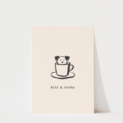 A simple illustration of a dog sitting inside a cup, accompanied by the text "RISE & SHINE" below it.