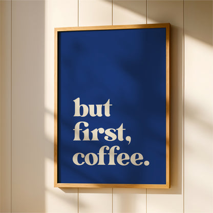 A framed poster with the text "but first, coffee."