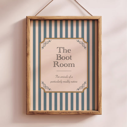 a framed sign with the text "The Boot Room" and decorative elements, hanging on a wall.
