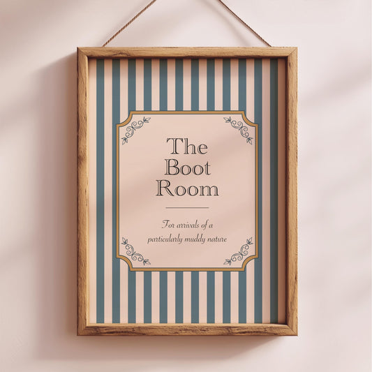 a framed sign with the text "The Boot Room" and decorative elements, hanging on a wall.
